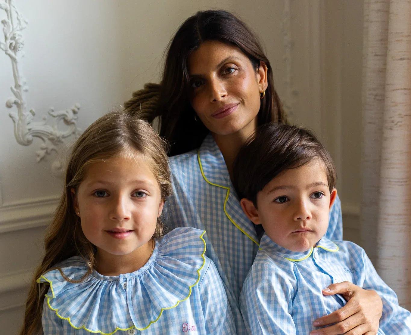 Picture of a mother and her children in a matchy matchy pajamas set